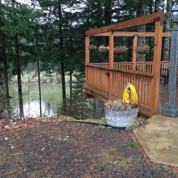 Chateau Lorane - a fire hydrant on a deck overlooking a lake - Wineries Near Me - Lorane, Oregon