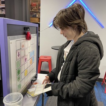 Reality Break Escapes - Kate solving a puzzle to get a snack out of the box! - Escape Games Near Me - Bellevue, Washington