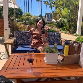 Pavilion Hotel - My friend enjoying complimentary wine on the patio before our boat arrives. - Hotels Near Me - Avalon, California Pavilion Hotel - My friend enjoying complimentary wine on the patio before our boat arrives. - Hotels Near Me - Avalon, California