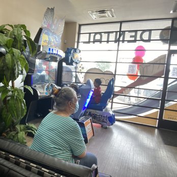 Laguna Dental - My kids loving the boat and car racing and my mother watching a movie - Pediatric Dentists Near Me - Irving, Texas