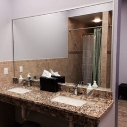 Radiance Hot Yoga - Granite counter top sinks in shower area.