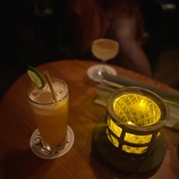 a table with a drink and a candle