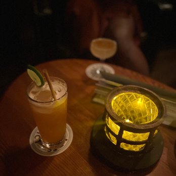 The Study - a table with a drink and a candle - Cocktail Bars Near Me - Los Angeles, California