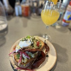 Lola’s Cafe Bar - Avocado toast add bacon and poached egg + mimosa