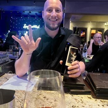 Spaghettini - Our favorite bartender, Patrick who provides the most attentive and amazing service! He is signing "I Love You".in ASL. - Italian Near Me - Seal Beach, California