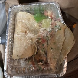 My beer battered fish tacos. One completely upside down and the other hanging out of the box. My beer battered fish tacos. One completely upside down and the other hanging out of the box.