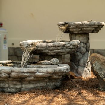 Life Enterprises - a stone fountain with water flowing from it - General Contractors Near Me Life Enterprises - a stone fountain with water flowing from it - General Contractors Near Me