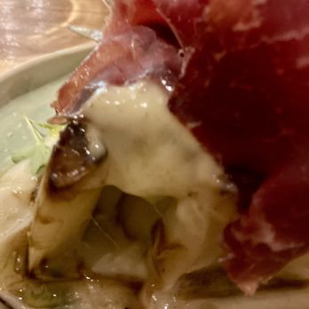La Panxa del Bisbe - Grilled leeks in a cream sauce and reduction, topped with jamon and dressed with bean sprouts - Catalan Near Me - Barcelona, B La Panxa del Bisbe - Grilled leeks in a cream sauce and reduction, topped with jamon and dressed with bean sprouts - Catalan Near Me - Barcelona, B