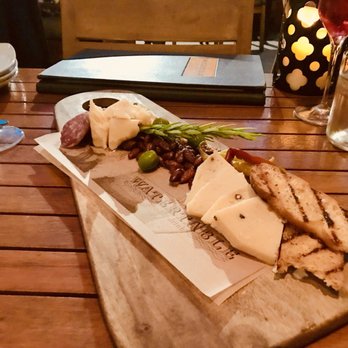 Watertable - Cheese plate with honey, almonds, olives, hard cheeses, salami, pickled peppers, grain mustard and more. - New American Near Me - Huntington Beach, California