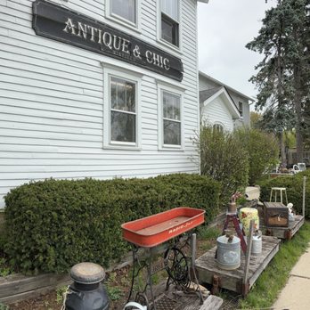 Antique & Chic Winfield - Outside the 3-story house - Exterior view of 'Antique & Chic' store with vintage decor, plants, and outdoor antiques along the sidewalk. - Antiques Near Me - Winfield, Illinois