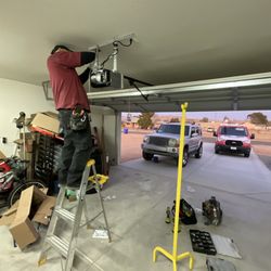 D&R Garage Door Repair - Jaime, is working on the Garage Door Motor electrical unit.