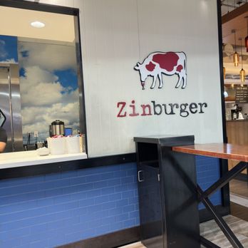 Zinburger - a man sitting at a table - Burgers Near Me - Phoenix, Arizona