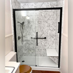 Expo Home Improvement - Grey and white walk-in shower renovation in style "Midnight Storm." This beautiful shower was customized to include a bench and grab bars.