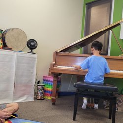 A high school student listening to a young pianist plays. Time flies seeing another generation coming to Green Octave.