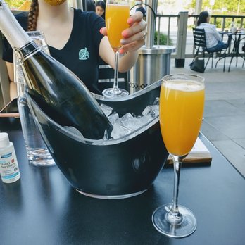 Woodblock - Bucket Mimosa - prosecco and blood orange juice mix. - Cocktail Bars Near Me - Redmond, Washington