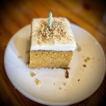 Slows Bar BQ - a slice of carrot cake with a single candle on top - Barbeque Near Me - Detroit, Michigan Slows Bar BQ - a slice of carrot cake with a single candle on top - Barbeque Near Me - Detroit, Michigan