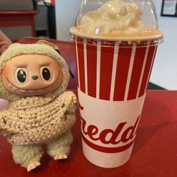 Freddy's Frozen Custard & Steakburgers - Labubu posing next to Orange Cream Frost
