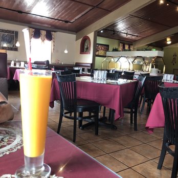 Taj Palace - Mango lassi and the buffet bar in the background. - Indian Near Me - Yakima, Washington