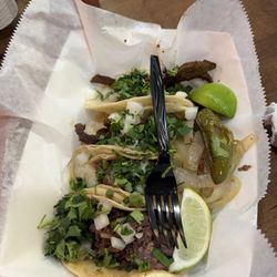 2 barbacoa tacos on corn tortilla, and 2 carne asada tacos on flour tortilla.