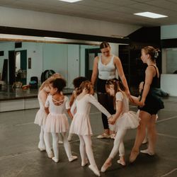 Riverwalk Dance Collective - Young dancers practice ballet in a tendu circle at Riverwalk Dance Collective--where confidence, technique, and fun come together.
