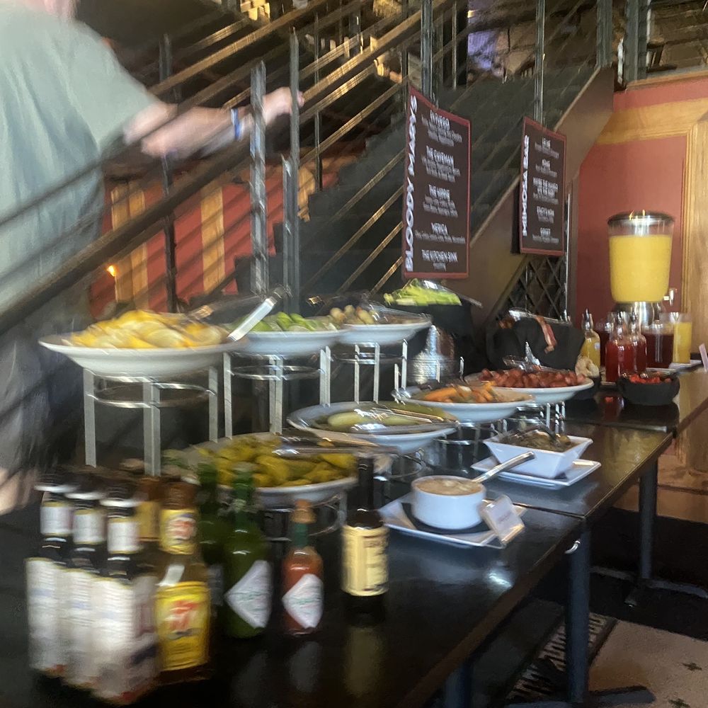 Americana - a man standing in front of a table full of food - New American Near Me - Des Moines, Iowa Americana - a man standing in front of a table full of food - New American Near Me - Des Moines, Iowa