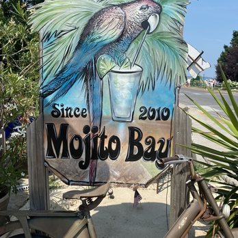 Mojito Bay - a bicycle parked in front of a sign - Tiki Bars Near Me - Put-in-Bay, Ohio