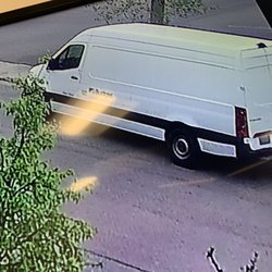 Budget Car Rental - The van is white with a budget emblem on the side, it says.