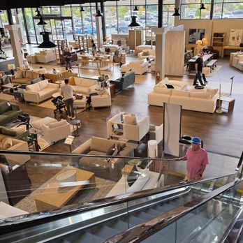 Living Spaces - A spacious furniture store with large windows, displaying sofas, tables, and decor, with customers shopping. - Home Decor Near Me - Lone Tree, Colorado