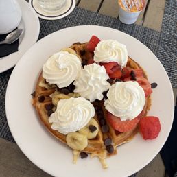 Waffle with fruits chocolate chips and whipped cream Waffle with fruits chocolate chips and whipped cream