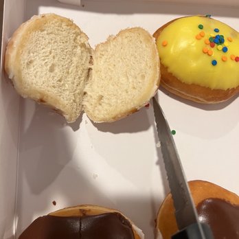 Krispy Kreme - a box of donuts with chocolate frosting and sprinkles - Donuts Near Me - Pensacola, Florida