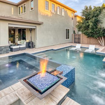 Unique Landscapes & Custom Pools - Custom Gilbert backyard pool with raised spa, fire bowls, Baja shelf loungers, and elegant water features for relaxing. - Landscape Architects or Designers Near Me - Chandler, Arizona Unique Landscapes & Custom Pools - Custom Gilbert backyard pool with raised spa, fire bowls, Baja shelf loungers, and elegant water features for relaxing. - Landscape Architects or Designers Near Me - Chandler, Arizona