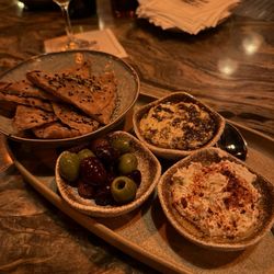 Bannock with labneh, hummus, and warm olives during happy hour