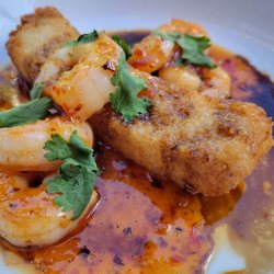 Black+Haus Tavern - Thai chili shrimp, sour spicy glaze, crispy rice, cilantro, sesame seeds, and sweet soy sauce.