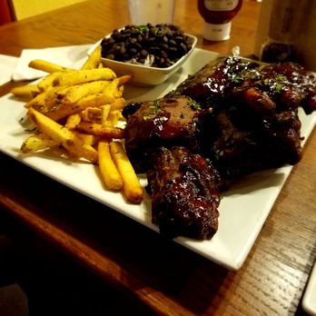 Hemingway's Tavern - Ribs platter with truffle fries, rice and black beans. Would recommend the ribs. The fries were tasty but a bit too salty. - New American Near Me - Melbourne, Florida