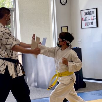 Innovative Martial Arts - Master Jake and student during board breaking - Martial Arts Near Me - Rocklin, California Innovative Martial Arts - Master Jake and student during board breaking - Martial Arts Near Me - Rocklin, California