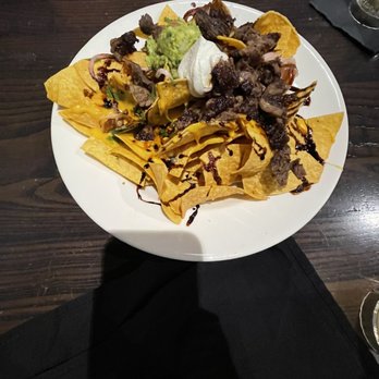 Local Goat - Steak Nachos* - New American Near Me - Pigeon Forge, Tennessee