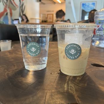 Carpenter Coffee Bar - Water + Iced Caramel Latte with Oat Milk - Coffee & Tea Near Me - Austin, Texas