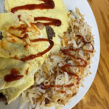 The Breakfast Place - Philly Cheese Omelette with hash browns (I added sriracha)   Very buttery and cheesy but not too salty. Good portion size. - Breakfast & Brunch Near Me - Savannah, Georgia