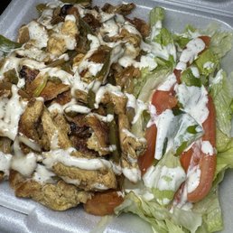 a salad in a styrofoam container