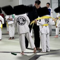 HK Taekwondo - 2 instructors putting on belts 2 different ways.  Yet Master Kim will embarrass a kid who doesn't tie his belt "Kim's way".