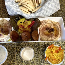 Baba ghanoush, dolmas,falafel,hummus, tzatziki, turmeric pickled peppers, garlic sauce and homemade Greek pita