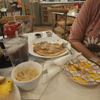 L’Amitié Bistro - Picture of the gravy, sausagewas crumbles as it should be and my daughters pancakes... - Breakfast & Brunch Near Me - Denton, Texas