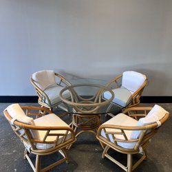 The ReBorn House - Rattan Chat Set with upholstered swivel seats and glass table top.