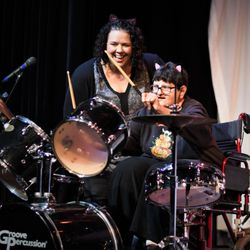 The Fine Arts Association - Creative Arts Therapies Client playing drums with Miss Danni