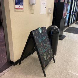 a chalkboard sign in a coffee shop