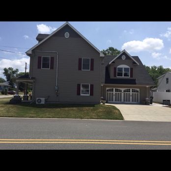 Pezzello Contracting - a two story house on a street corner - General Contractors Near Me