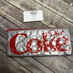 This is an actual Diet Coke carton that I scraped the cardboard from the back, covered with vinyl and quilted the layers together.  Zipperd