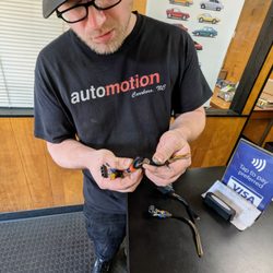 Automotion - Owner Gunnar showing me my old ignition coil connectors that had worn out and disintegrated. Gunnar is the man.