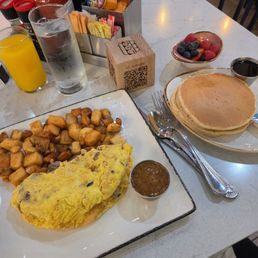 Brisket omelet with mini pancakes fruit bowl and potatoes Brisket omelet with mini pancakes fruit bowl and potatoes