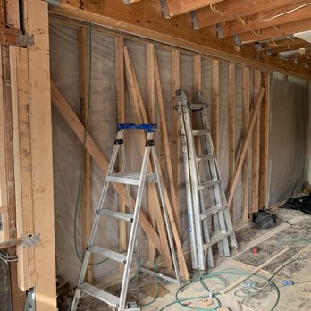 Pure Energy Construction - Major beam installation (shown with temporary wall) to open up small kitchen to living room to create an amazing space. - General Contractors Near Me - Northridge, California Pure Energy Construction - Major beam installation (shown with temporary wall) to open up small kitchen to living room to create an amazing space. - General Contractors Near Me - Northridge, California